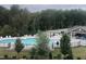 Scenic view of the community pool area surrounded by lush greenery and mature trees at 233 Pointe Park Cir, Holly Springs, NC 27540