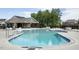 Inviting community pool with lounge chairs and umbrellas for relaxation in a serene setting at 233 Pointe Park Cir, Holly Springs, NC 27540