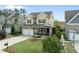 Charming two-story home with a covered front porch, attached garage, and well-manicured lawn at 233 Pointe Park Cir, Holly Springs, NC 27540