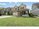 Charming two-story home with a welcoming front porch and well-manicured lawn at 233 Pointe Park Cir, Holly Springs, NC 27540