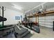 Well-equipped garage gym featuring weights, machines, and a TV for entertainment at 233 Pointe Park Cir, Holly Springs, NC 27540