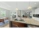 Bright kitchen with stainless sink, island, and pendant lighting at 233 Pointe Park Cir, Holly Springs, NC 27540