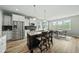 Bright and open kitchen with stainless appliances, center island, and adjacent dining area at 233 Pointe Park Cir, Holly Springs, NC 27540