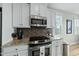 Updated kitchen with stainless appliances, granite counters, and white cabinets at 233 Pointe Park Cir, Holly Springs, NC 27540