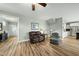 Spacious living room with hardwood floors, comfortable seating, and access to the kitchen at 233 Pointe Park Cir, Holly Springs, NC 27540