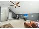 Spacious living room featuring a TV, ceiling fan, and comfortable seating area at 233 Pointe Park Cir, Holly Springs, NC 27540
