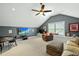 Spacious living room with a ceiling fan, TV, and comfortable seating at 233 Pointe Park Cir, Holly Springs, NC 27540