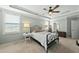 Main bedroom with tray ceiling, fan, and plenty of natural light at 233 Pointe Park Cir, Holly Springs, NC 27540