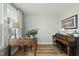 Well-lit office space with wooden floors, a piano, and a view of the outdoors at 233 Pointe Park Cir, Holly Springs, NC 27540