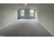 Spacious bedroom with soft carpet, neutral walls, and two large windows for natural light at 236 Paramount Dr, Smithfield, NC 27577