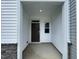Welcoming covered entryway with a dark wood door and a sidelight window for natural illumination at 236 Paramount Dr, Smithfield, NC 27577