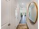Inviting hallway with a round mirror and hardwood floors throughout the main level of the home at 236 Paramount Dr # 22, Smithfield, NC 27577