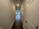 Bright hallway leading to an open living area, featuring neutral walls and modern lighting at 236 Paramount Dr, Smithfield, NC 27577