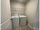 Functional laundry room with washer, dryer and practical wire shelving for storage at 236 Paramount Dr, Smithfield, NC 27577
