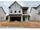 New two-story home featuring a spacious garage and covered porch awaiting finishing touches at 255 Meadowbark Bnd # 31, Garner, NC 27529