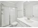 Well-lit bathroom featuring a glass shower door, vanity with sink, neutral wall color, and tiled flooring at 2613 Red Spruce Dr, Raleigh, NC 27616