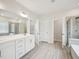 Bathroom suite featuring a dual sink vanity with ample cabinet space, plus a shower and separate toilet room at 2613 Red Spruce Dr, Raleigh, NC 27616