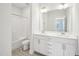 Bathroom featuring double sinks, modern fixtures, tub/shower with white tile, and neutral color palette at 2613 Red Spruce Dr, Raleigh, NC 27616