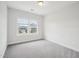 Bedroom features a large window, plush carpet, and white walls, perfect for relaxing at 2613 Red Spruce Dr, Raleigh, NC 27616