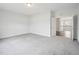 A spacious bedroom featuring neutral carpeting, paint and an open doorway to the upstairs hall at 2613 Red Spruce Dr, Raleigh, NC 27616