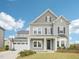 Charming two-story home with gray siding, black shutters, an attached garage and a basketball hoop out front at 2613 Red Spruce Dr, Raleigh, NC 27616