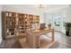 Bright home office with a large desk, bookshelf, and a bay window at 2613 Red Spruce Dr, Raleigh, NC 27616