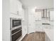 Modern kitchen with white cabinets, stainless steel appliances, and a stylish backsplash at 2613 Red Spruce Dr, Raleigh, NC 27616