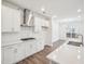 Bright kitchen features white cabinets, stainless steel appliances, subway tile backsplash, and expansive quartz countertops at 2613 Red Spruce Dr, Raleigh, NC 27616