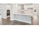 Spacious kitchen with an island that features a textured accent wall, stainless steel appliances, and quartz countertop at 2613 Red Spruce Dr, Raleigh, NC 27616