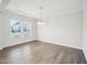 Large, well-lit living room with beautiful wood floors and bright, sunny windows at 2613 Red Spruce Dr, Raleigh, NC 27616
