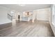 Open-concept floor plan with wood floors connecting the living room, kitchen, and dining area at 2613 Red Spruce Dr, Raleigh, NC 27616