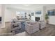 Bright living room with a fireplace, large windows, gray sofas and armchairs, and a blue patterned rug at 2613 Red Spruce Dr, Raleigh, NC 27616