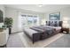 Stylishly decorated primary bedroom featuring a plush bed, soft rug, and serene color scheme with ample natural light at 2613 Red Spruce Dr, Raleigh, NC 27616
