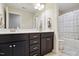 Bathroom features a double sink vanity with dark cabinets and a tub with a shower at 263 Annali Way, Wendell, NC 27591