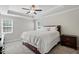 Calm primary bedroom with tray ceiling, carpet flooring, and neutral paint, offering a soothing retreat at 263 Annali Way, Wendell, NC 27591
