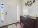 Bright entryway featuring wood floors, white front door with sidelights, and a dark wood console at 263 Annali Way, Wendell, NC 27591