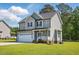 Charming two-story home with a manicured lawn, attached garage, and inviting front porch at 263 Annali Way, Wendell, NC 27591