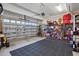 Spacious garage with ample storage space, including shelving units and room for a lawn tractor at 263 Annali Way, Wendell, NC 27591
