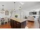 Bright, open kitchen featuring a center island with granite countertops, dark cabinetry, and pendant lighting at 263 Annali Way, Wendell, NC 27591