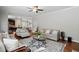 Inviting living room with hardwood floors, neutral furniture, and an open layout to the kitchen and dining area at 263 Annali Way, Wendell, NC 27591