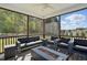 Relaxing screened-in porch features comfortable seating around a fire pit at 263 Annali Way, Wendell, NC 27591