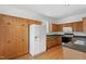 Traditional kitchen featuring wood cabinets, a white refrigerator, and dark countertops at 269 Sweet Bay Pl, Carrboro, NC 27510