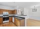 Efficient kitchen with wood cabinetry, laminate countertops, and stainless-steel sink at 269 Sweet Bay Pl, Carrboro, NC 27510