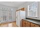 Bright kitchen area featuring light-colored cabinetry, window, and access to a patio at 269 Sweet Bay Pl, Carrboro, NC 27510