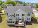 Stunning aerial view showcases the home's deck and manicured lawn backing to a wooded view at 316 Hilliard Forest Dr, Cary, NC 27519