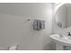 Neat half bath features a pedestal sink, towel bar, and a round mirror at 316 Hilliard Forest Dr, Cary, NC 27519