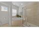 Well-lit bathroom featuring a soaking tub, a separate shower with tile surround, and neutral finishes at 316 Hilliard Forest Dr, Cary, NC 27519