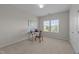 Carpeted room with a desk, chair, window, and neutral-colored walls at 316 Hilliard Forest Dr, Cary, NC 27519