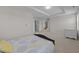 Bright bedroom showing bed, open door with stairway beyond, and a baby bed at 316 Hilliard Forest Dr, Cary, NC 27519
