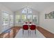 Bright dining area featuring large windows, stylish chandelier, and sleek table with red chairs at 316 Hilliard Forest Dr, Cary, NC 27519